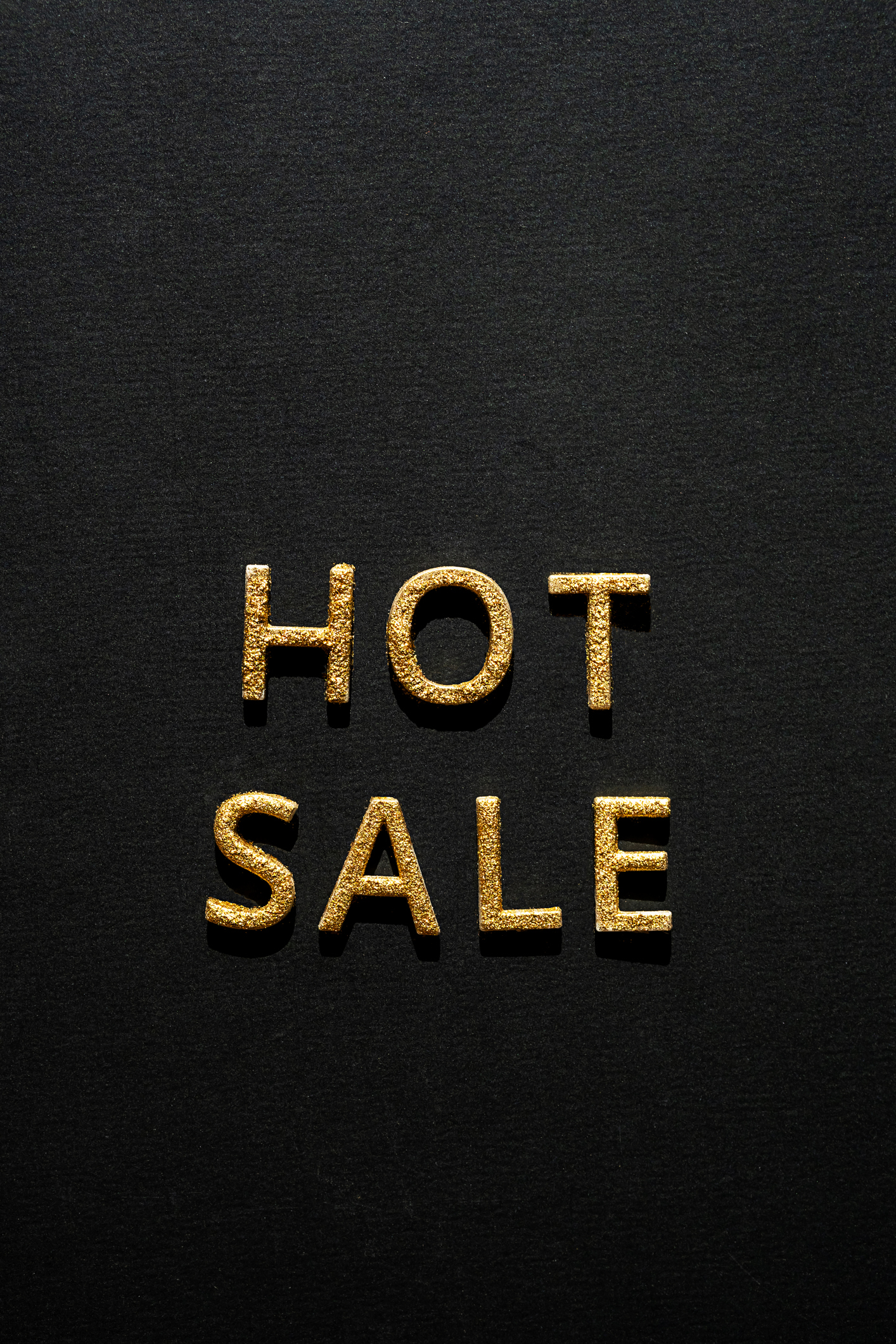 Hot sale – golden words on black. Online sale or clearance store concept.